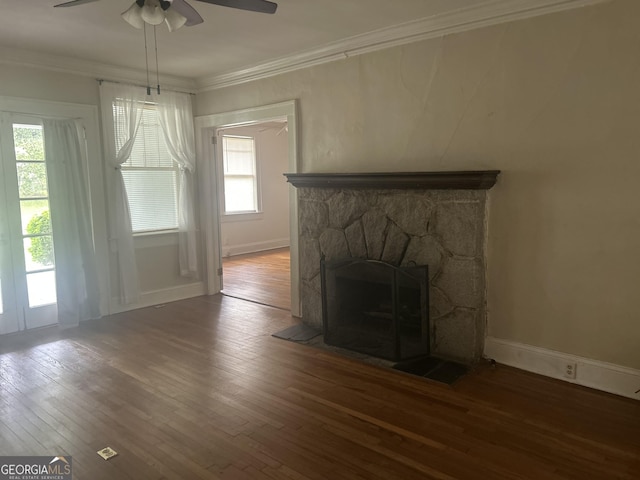 unfurnished living room with a wealth of natural light, ornamental molding, ceiling fan, and wood finished floors