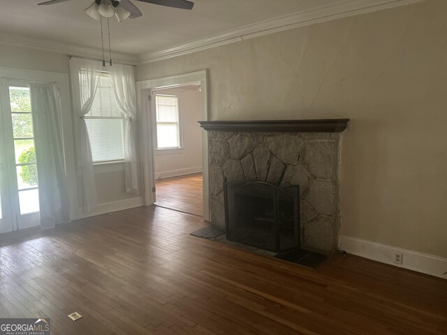 3776 Berkley Dr, Macon, GA 31204 - unfurnished living room with wood-type flooring, a ceiling fan, a stone fireplace, ornamental molding, and baseboards