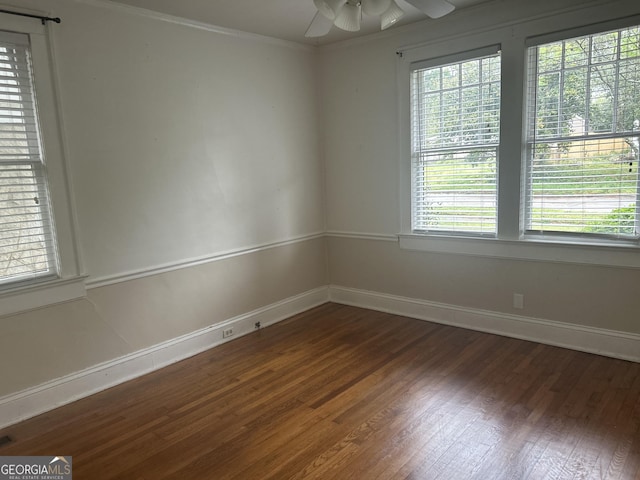 unfurnished room featuring baseboards, ornamental molding, wood finished floors, a ceiling fan, and a healthy amount of sunlight