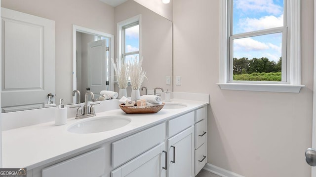 52 Sheryl Way, Loganville, GA 30052 - bathroom featuring double vanity and baseboards