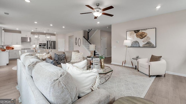 52 Sheryl Way, Loganville, GA 30052 - living room featuring recessed lighting, light wood finished floors, a ceiling fan, and stairway