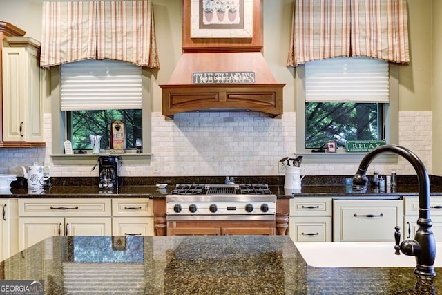 2373 Herman Drake Rd, Young Harris, GA 30582 - kitchen featuring dark stone countertops, a wealth of natural light, a sink, and tasteful backsplash