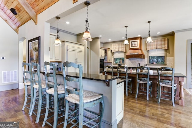2373 Herman Drake Rd, Young Harris, GA 30582 - kitchen featuring wood ceiling, wood finished floors, a breakfast bar, visible vents, and decorative backsplash