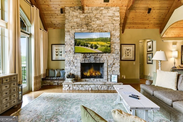 2373 Herman Drake Rd, Young Harris, GA 30582 - living room featuring wood ceiling, lofted ceiling with beams, wood finished floors, a stone fireplace, and arched walkways