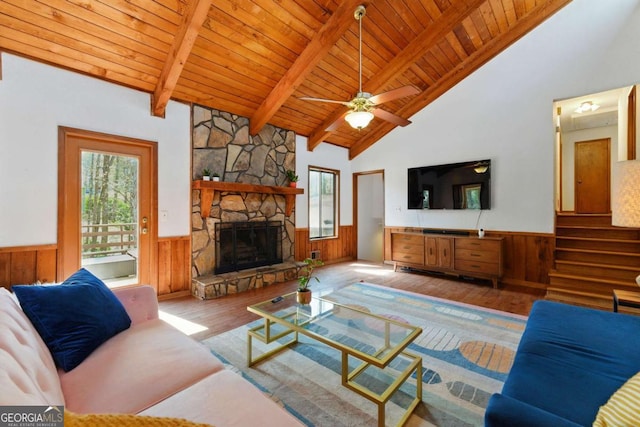 living room with wood ceiling, a wealth of natural light, and wainscoting