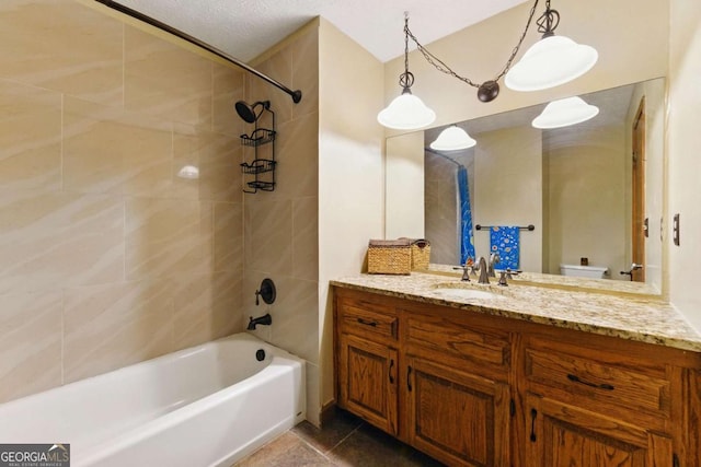 bathroom with tub / shower combination, toilet, tile patterned floors, and vanity