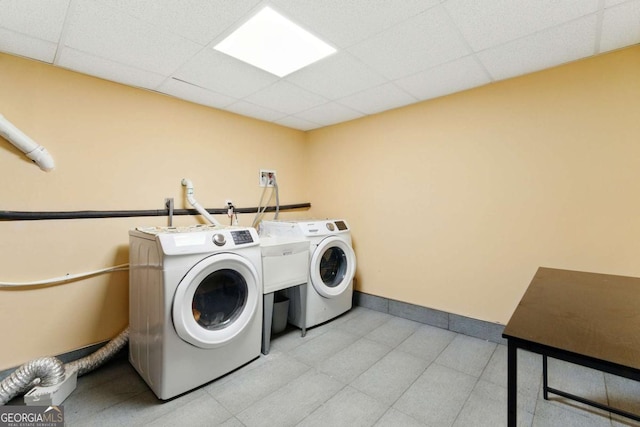 laundry area with baseboards, washing machine and dryer, and laundry area