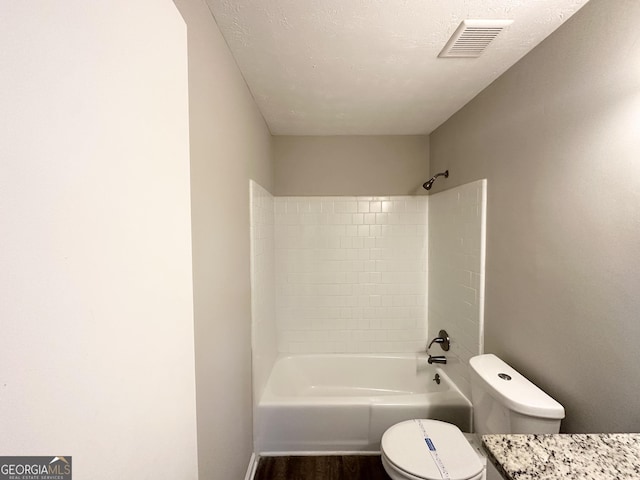 2317 Emerald Springs Dr, Decatur, GA 30035 - bathroom featuring a textured ceiling, visible vents, toilet, wood finished floors, and shower / bathtub combination