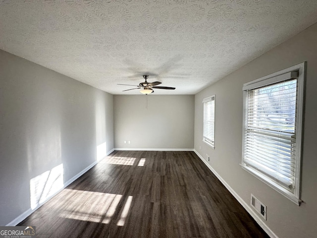 2317 Emerald Springs Dr, Decatur, GA 30035 - empty room featuring dark wood finished floors, baseboards, visible vents, and a ceiling fan