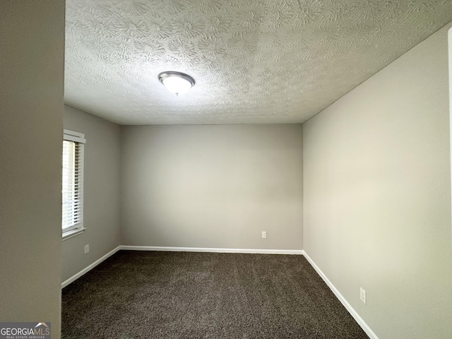 2317 Emerald Springs Dr, Decatur, GA 30035 - unfurnished room with baseboards, dark carpet, and a textured ceiling