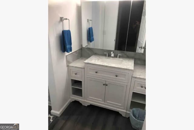 3834 Kensingwood Trce, Decatur, GA 30032 - bathroom with baseboards, wood finished floors, and vanity