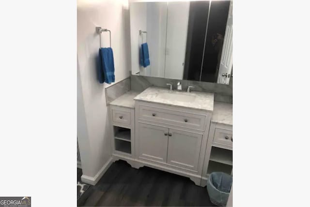 3834 Kensingwood Trce, Decatur, GA 30032 - bathroom with baseboards, wood finished floors, and vanity