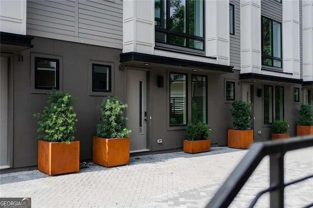 property entrance with stucco siding