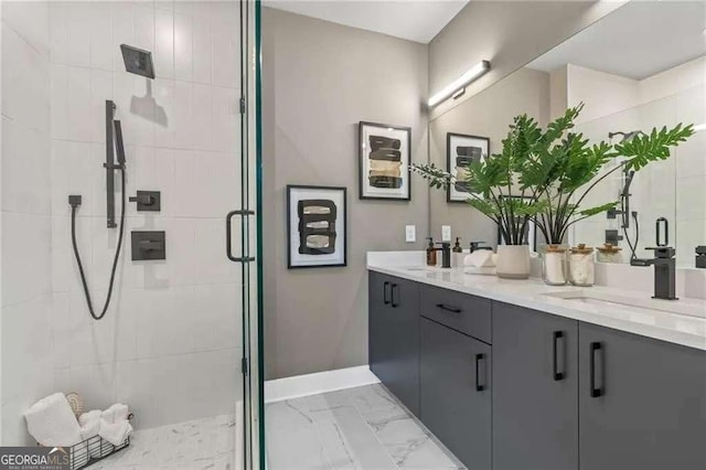 bathroom featuring baseboards, a sink, double vanity, marble finish floor, and a stall shower