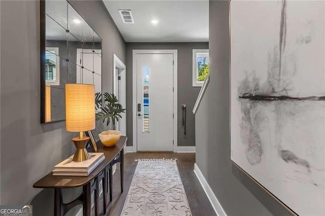 interior space featuring wood finished floors, baseboards, and visible vents
