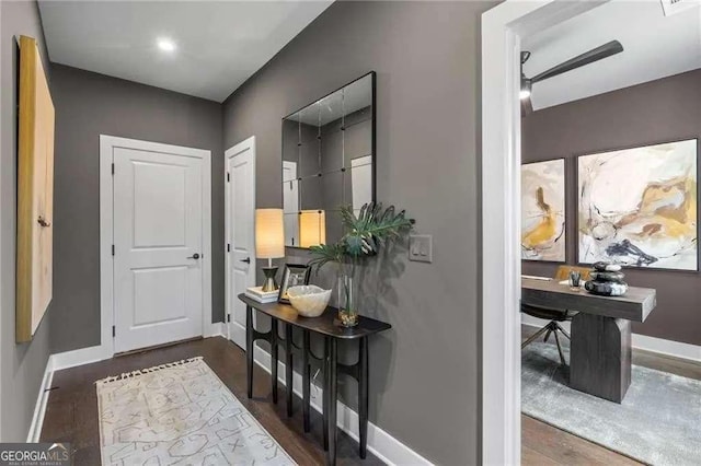 foyer entrance featuring wood finished floors, baseboards, and a ceiling fan