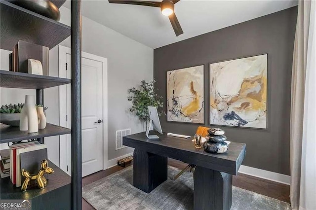 home office with wood finished floors, ceiling fan, baseboards, and visible vents