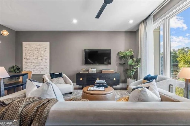 living room featuring wood finished floors, baseboards, a ceiling fan, and recessed lighting