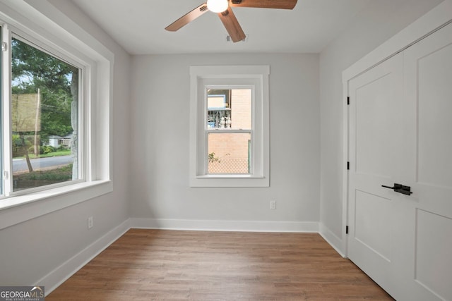 1441 Ezra Church Dr NW, Atlanta, GA 30314 - unfurnished room featuring light wood finished floors, baseboards, a ceiling fan, and a healthy amount of sunlight