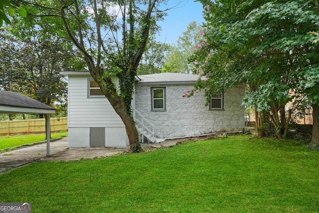 1441 Ezra Church Dr NW, Atlanta, GA 30314 - view of side of home featuring a patio area, fence, and a yard