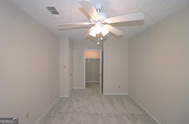2929 Torreya Way SE, Marietta, GA 30067 - spare room with light carpet, baseboards, ceiling fan, and a textured ceiling
