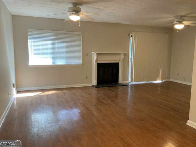 2929 Torreya Way SE, Marietta, GA 30067 - unfurnished living room featuring ceiling fan, wood finished floors, and baseboards