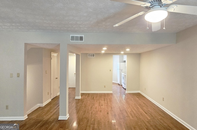 2929 Torreya Way SE, Marietta, GA 30067 - basement featuring freestanding refrigerator, wood finished floors, baseboards, a textured ceiling, and ceiling fan