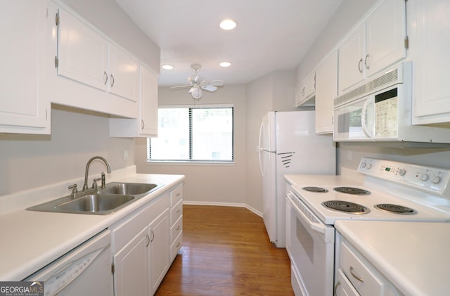 2929 Torreya Way SE, Marietta, GA 30067 - kitchen featuring white appliances, a sink, wood finished floors, white cabinets, and recessed lighting