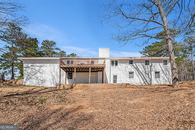 9640 Cedar Grove Rd, Fairburn, GA 30213 - back of house with a wooden deck, stucco siding, and a chimney
