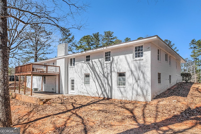 9640 Cedar Grove Rd, Fairburn, GA 30213 - rear view of house featuring a chimney, a deck, and brick siding