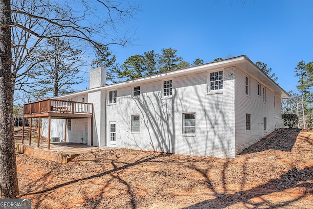 9640 Cedar Grove Rd, Fairburn, GA 30213 - rear view of house with a chimney, a deck, and brick siding
