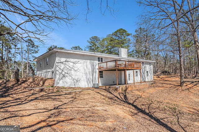 9640 Cedar Grove Rd, Fairburn, GA 30213 - rear view of house featuring a chimney, a deck, central AC, and brick siding