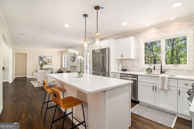 9640 Cedar Grove Rd, Fairburn, GA 30213 - kitchen with appliances with stainless steel finishes, a sink, a center island, a breakfast bar, and decorative backsplash