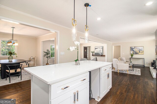 9640 Cedar Grove Rd, Fairburn, GA 30213 - kitchen with dark wood-type flooring, white cabinetry, a center island, light countertops, and ornamental molding