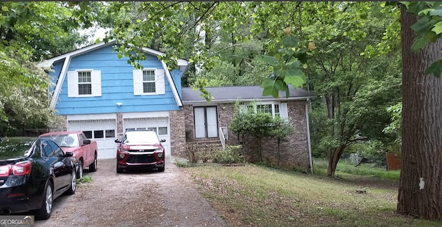 tri-level home featuring brick siding, a garage, and aphalt driveway