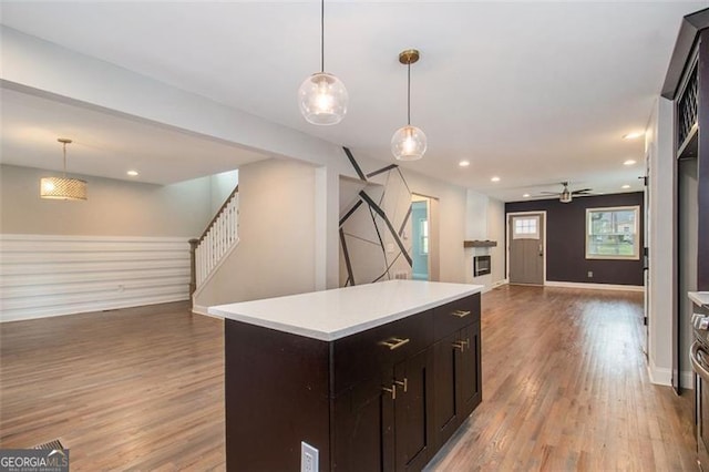 kitchen with light wood finished floors, open floor plan, and a center island