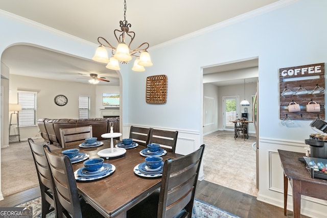 6018 Cloverfield Way, Braselton, GA 30517 - dining room with arched walkways, ceiling fan, crown molding, a chandelier, and dark wood finished floors
