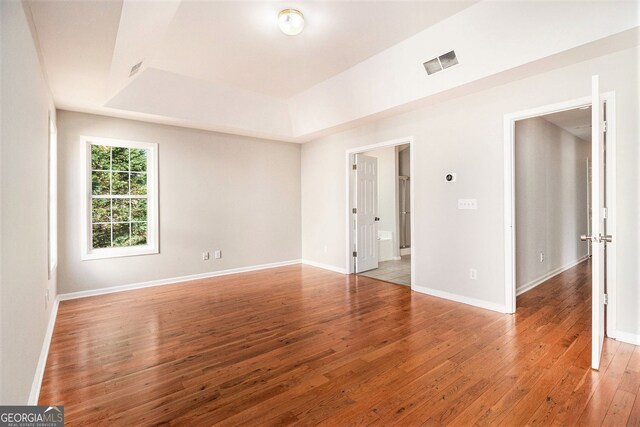 3707 Mcguire St NW, Kennesaw, GA 30144 - empty room featuring light wood-style floors, a tray ceiling, and baseboards