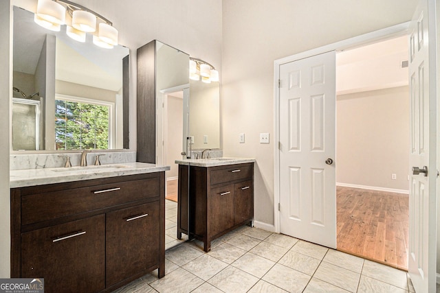 3707 Mcguire St NW, Kennesaw, GA 30144 - full bath featuring tile patterned flooring, two vanities, and baseboards