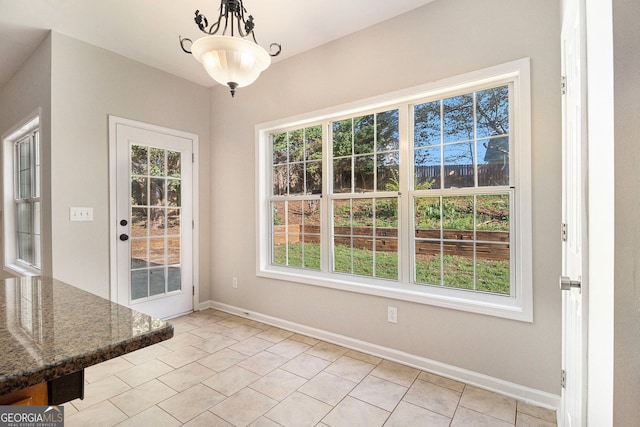3707 Mcguire St NW, Kennesaw, GA 30144 - unfurnished dining area with baseboards and light tile patterned floors