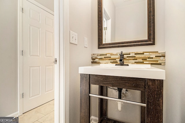 3707 Mcguire St NW, Kennesaw, GA 30144 - bathroom with backsplash, a sink, tile patterned floors, and baseboards