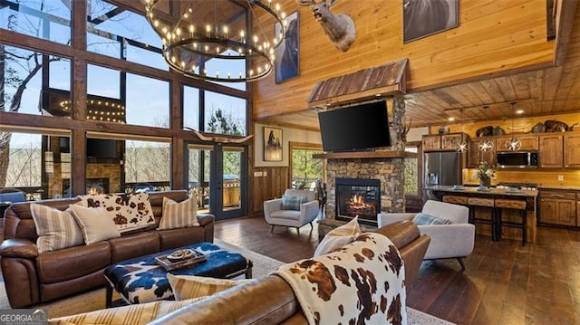 68 Shalom Vw, Blue Ridge, GA 30513 - living area featuring a stone fireplace, wood ceiling, dark wood finished floors, a chandelier, and a high ceiling