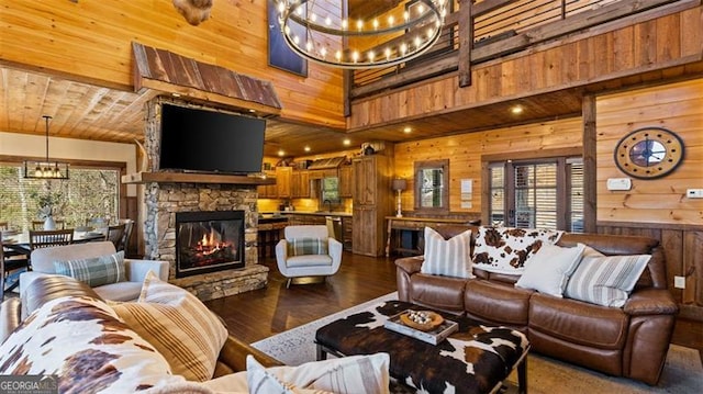 68 Shalom Vw, Blue Ridge, GA 30513 - living room with wood walls, a chandelier, healthy amount of natural light, dark wood-type flooring, and a fireplace