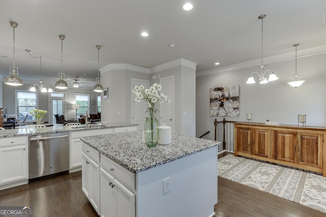 kitchen with dishwasher, a sink, a kitchen island, dark wood-style flooring, and crown molding