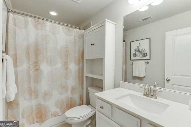 bathroom featuring toilet, vanity, and curtained shower