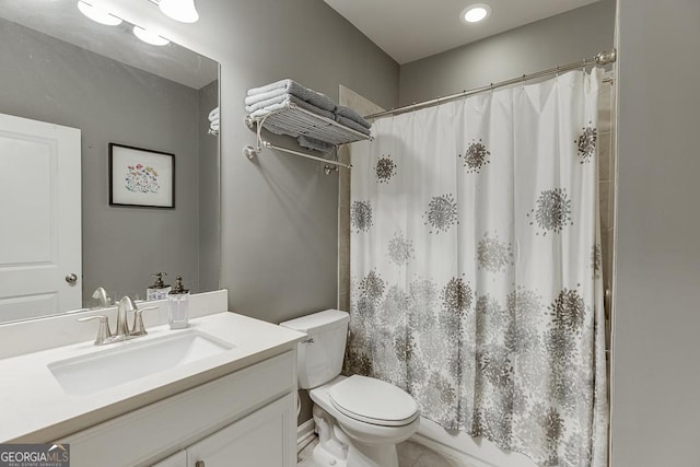 bathroom with toilet, vanity, and a shower with curtain