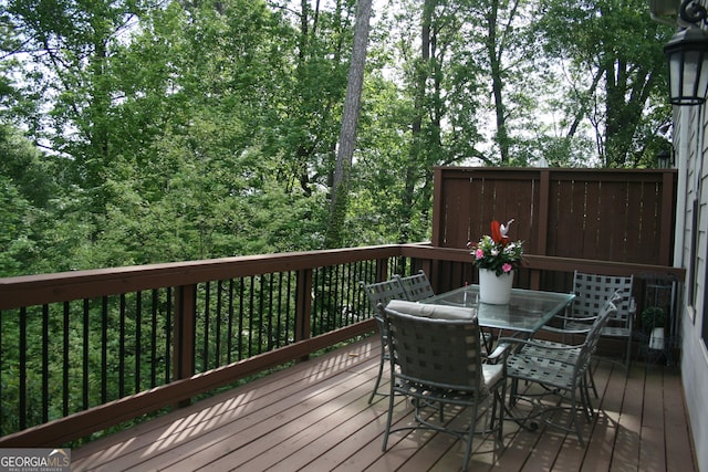 wooden terrace featuring outdoor dining area