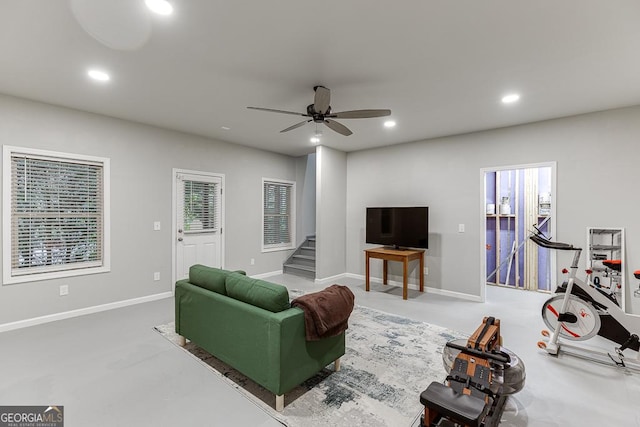 living room featuring stairs, recessed lighting, a ceiling fan, baseboards, and concrete floors
