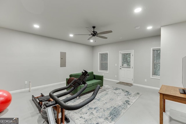 sitting room with a ceiling fan, electric panel, recessed lighting, concrete floors, and baseboards