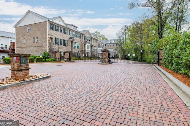 surrounding community featuring a residential view, a gate, and fence